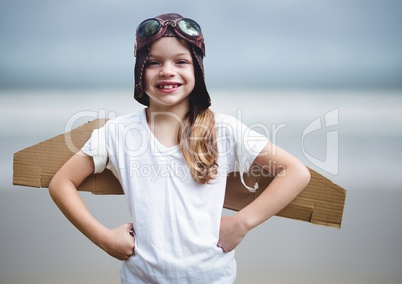 Girl in pilot costume against blurry beach