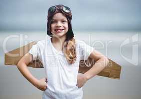 Girl in pilot costume against blurry beach