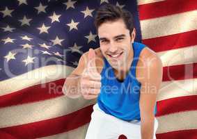 Sporty man thumb up against american flag