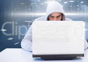 Hacker using a laptop in a room
