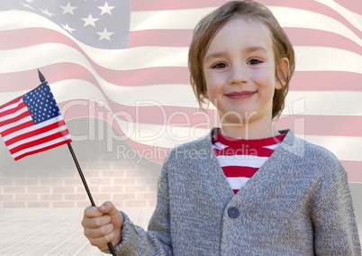 Smiling boy holding an american flag for independence day