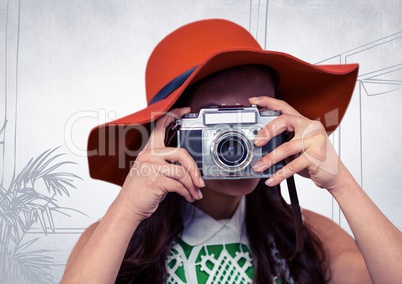 Millennial woman with sunhat and camera against white hand drawn office