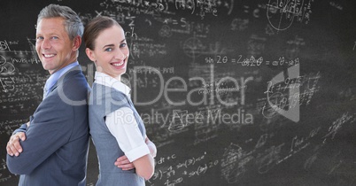 Business people back to back against grey wall with math doodles