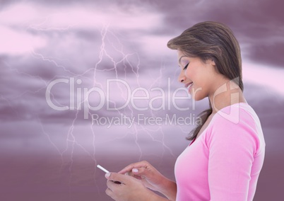 Smiling woman texting against fireworks on background