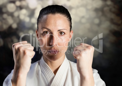 Woman in karate suit against bokeh