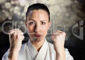 Woman in karate suit against bokeh