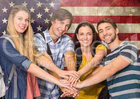 Friends with hands together against american flag