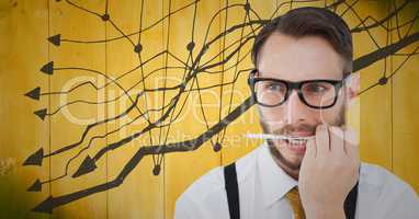 Frustrated business man with pen in mouth against 3D yellow wood panel and graph