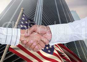 Business man shaking their hands against 3D american flag and skyscraper