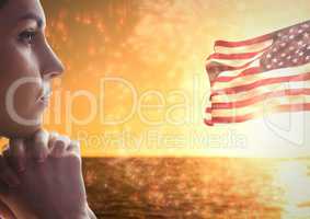 Woman thinking against sea and american flag