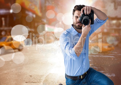 photographer taking a photo in te city with flares and blurred lights everywhere