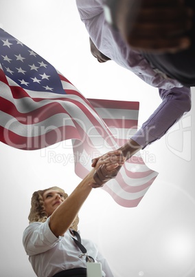 people shaking their hands against american flag