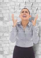 Frustrated business woman against white brick wall and exclamation points