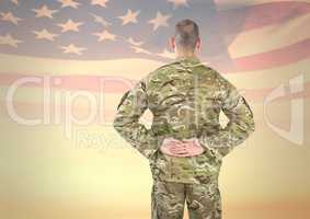 Soldier from back with hands on the back against american flag