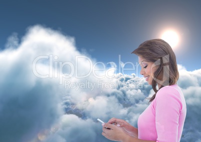 Smiling woman texting with 3D clouds and sun in background