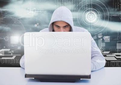 Hacker using a laptop in front of digital background