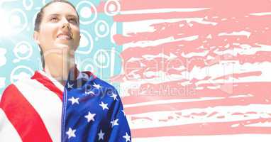 Woman wrapped in american flag looking up with flare against hand drawn american flag