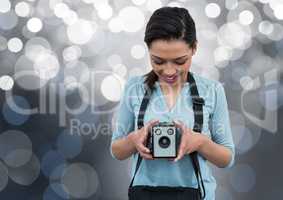 happy photographer with vintage camera. Silver bokeh behind