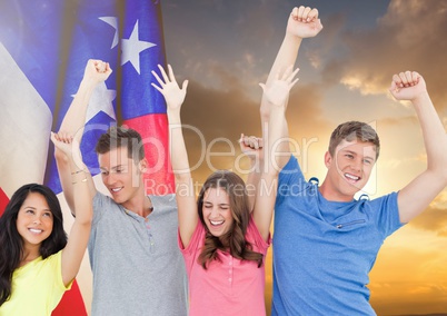 Friends raising their arms against sunset and american flag