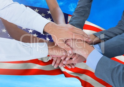 People putting their hands together against fluttering american flag background