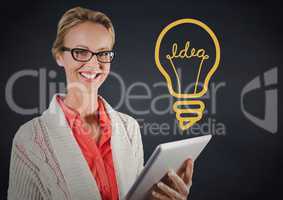 Business woman with tablet against navy wall with yellow idea graphic
