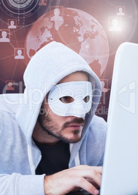 Hacker with a mask using a laptop in front of 3d digital background