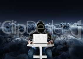 Hacker using a laptop in front of 3d cloudy black background