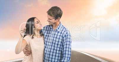 Couple Holding Keys with road