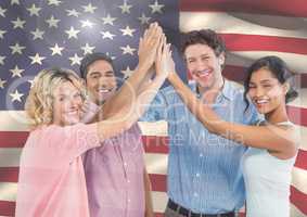 ASmiling Friends with hands together against american flag