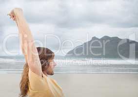 Man stretching against blurry beach