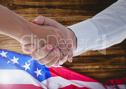 people shaking their hands against american flag