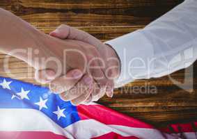 people shaking their hands against american flag