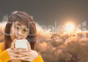 Woman Texting in 3D clouds with sunset