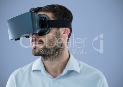 Man in virtual reality headset against purple background