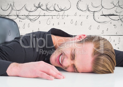 Frustrated business man at desk against white wood panel and rain graphics