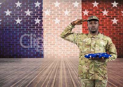 Soldier with hand on head holding an american flag in front of french flag