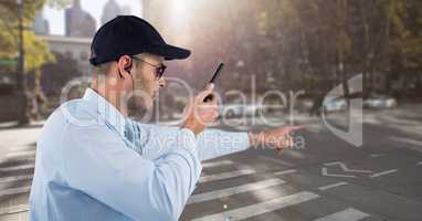 Security guard holding walkie talkie while pointing on road