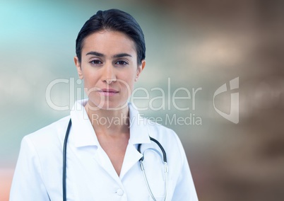 Female doctor against blurry blue brown background