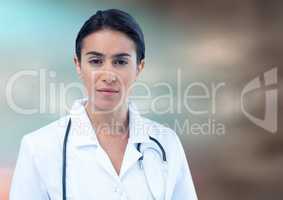 Female doctor against blurry blue brown background