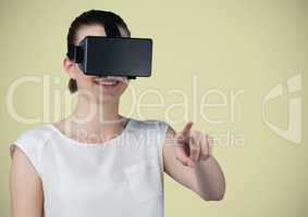 Woman in virtual reality headset against light green background