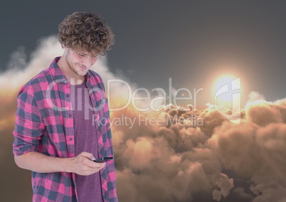 Smiling man texting with dark 3D clouds and sun in background