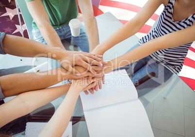 Friends with hands together against american flag