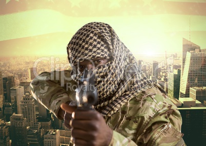 Soldier aiming the lens with his weapon in front of city buildings background