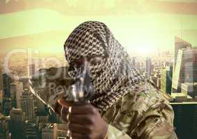 Soldier aiming the lens with his weapon in front of city buildings background