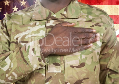 Close up of soldier with hand on heart in front of american flag