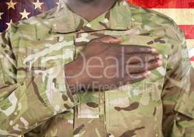 Close up of soldier with hand on heart in front of american flag