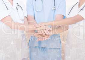 Doctors putting their hands together