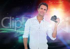 Photographer holding a camera against galaxy background