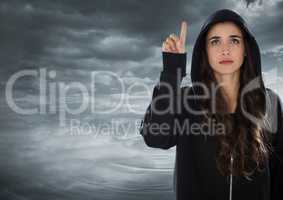 Woman hacker raising his finger in front of cloudy background