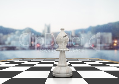 3D Chess piece against blurry skyline